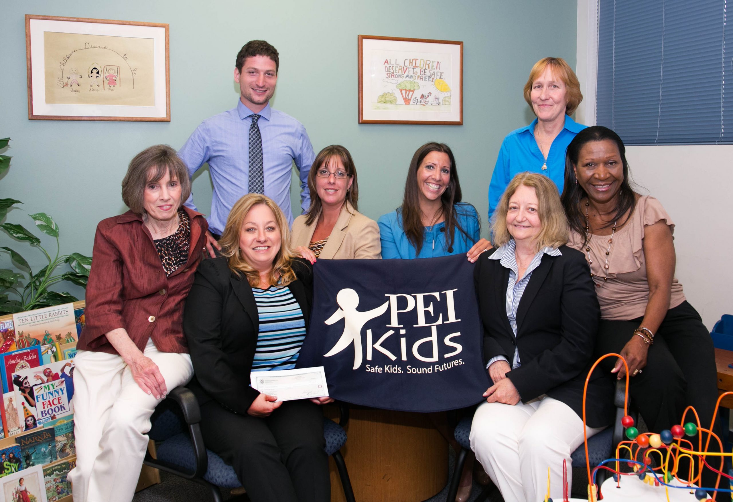 Investors Bank representatives present PEI Kids board members and staff with a donation from Investors Foundation in July 2014.