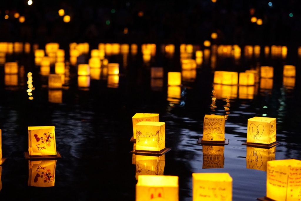 Paper lanterns on a lake at night