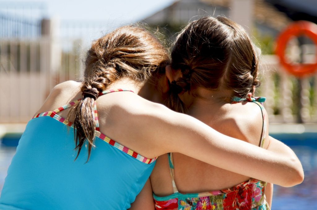Big sister looking after her little sister