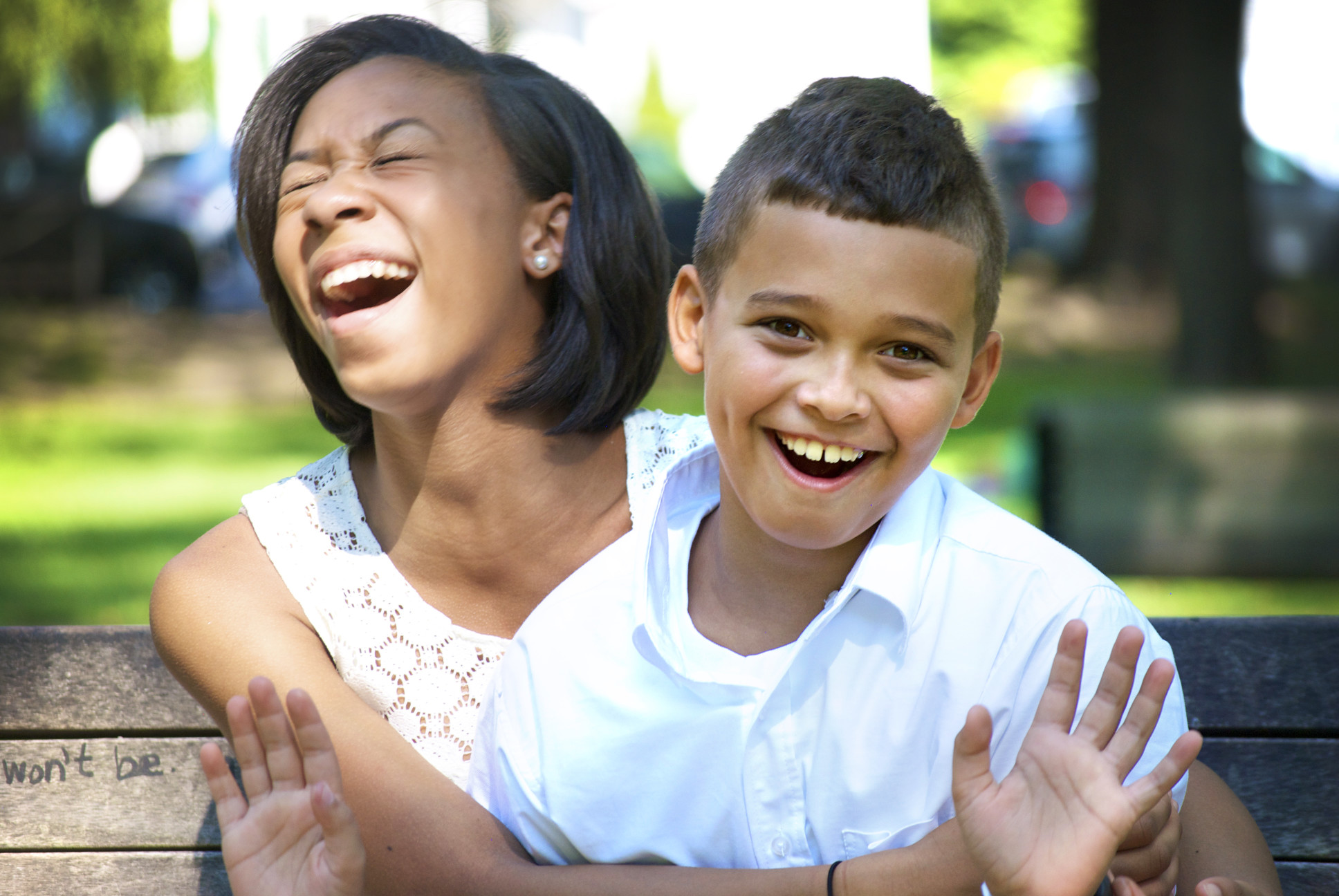 Siblings laughing and having fun outside
